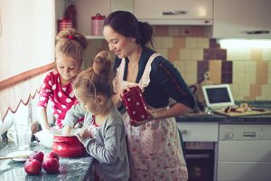 Mother in kitchen with two kids
