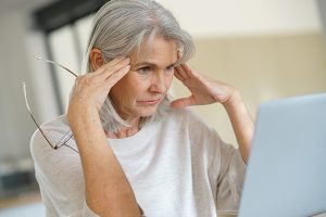 Retired woman looking at computer