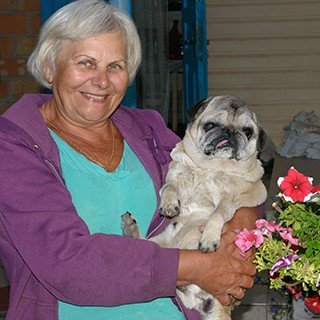 Senior woman holding dog
