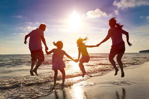 Family jumping on the beach