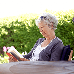 Woman sitting at a table reading a book